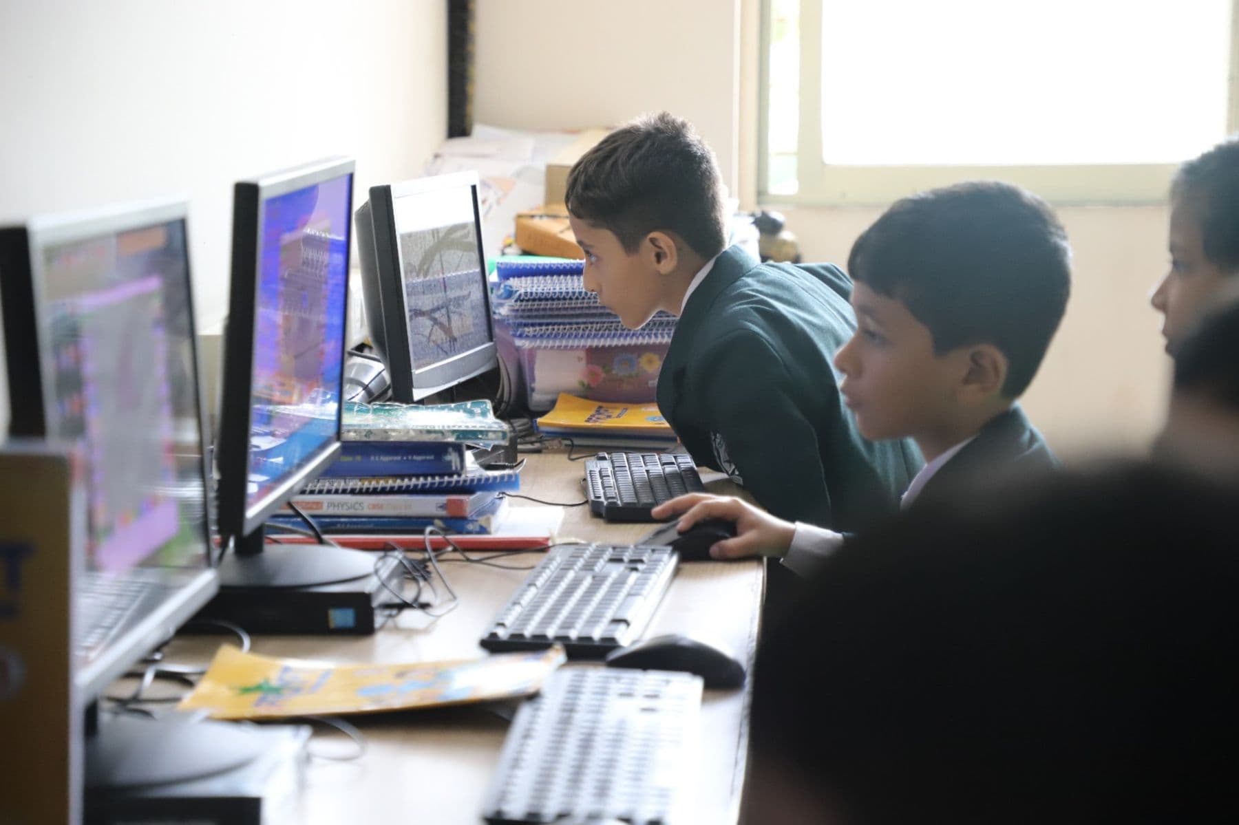 Two students working at computers in the school lab