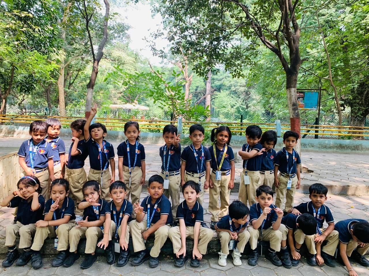A class of students on a visit in a green park