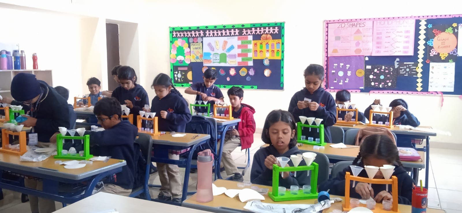 Children in lab doing a science experiment with test tubes and pipettes