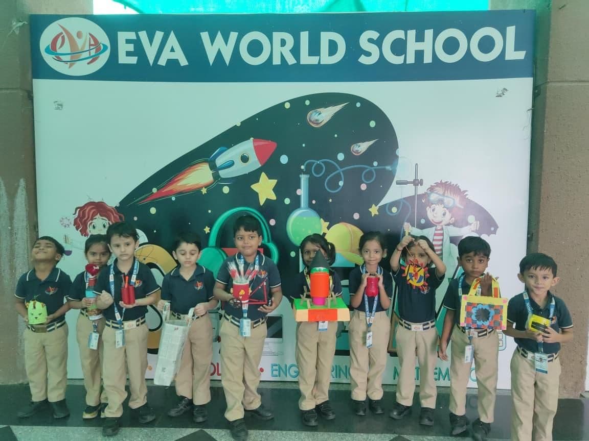 Pre-Primary students posing in front of a space-themed STEM wall
